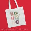 White tote bag with “HO HO HO” in festive letters, featuring a Christmas hat, a wreath, and a cheerful Winnie the Pooh character in the center. The background is bright red.