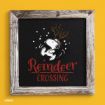 Framed art of Snoopy wearing reindeer antlers and earmuffs, with snow falling. Text below reads “Reindeer Crossing” in red. Background is black, with a rustic wooden frame and a yellow wall behind.