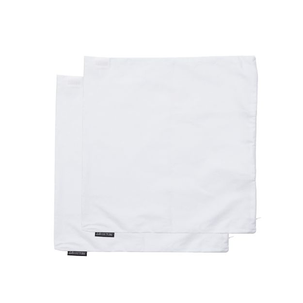 Two white square cloth napkins overlap on a plain white background. Each napkin has a small black label in one corner with white text. The fabric appears smooth and neatly folded.