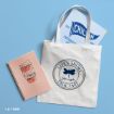 A white tote bag with “Life’s Short, Talk Fast” and a Gilmore Girls logo, a Chilton folder, and a spiral notebook with a coffee cup and “Coffee makes it a perfect morning” on a blue background.