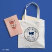 A white tote bag with “Life’s Short, Talk Fast, Gilmore Girls” and a butterfly logo beside a pink notebook with a coffee cup illustration on a blue background.
