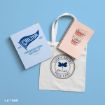 A tote bag with “Life’s Short Talk Fast,” a Chilton folder, and a pink notebook with a coffee cup illustration are arranged on a light blue background.