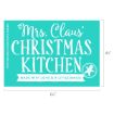 A teal sign reads “Mrs. Claus’ Christmas Kitchen. Made with love & a little magic,” with a white gingerbread cookie illustration in the corner and measurements shown on the sides.
