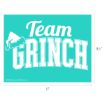 Turquoise rectangle with white text reading “Team Grinch.” “Team” is in cursive, and “Grinch” is in bold block letters. A Santa hat decorates the “T.” Dimensions are 11 inches by 8.5 inches.