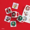 Disney-themed mugs, coasters, and stickers featuring cartoon characters, including Mickey Mouse, Minnie Mouse, Donald Duck, and Pluto, displayed on a bright red background.