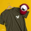 Olive green t-shirt with a Mickey Mouse logo on the pocket and a red and white cap with a black Mickey Mouse logo, displayed on a yellow background.