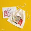 A white drawstring bag and a paper, both featuring a cartoon mouse in a Santa costume mailing a letter in a red mailbox, are displayed on a yellow background.