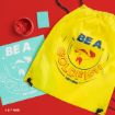Yellow drawstring bag reads “Be a Goldfish Ted Lasso” with a goldfish illustration. Also shown: a paint jar, blue card, and blue sheet with matching design, all on a red background.