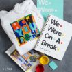 A white hoodie and notebooks feature colorful text and designs inspired by the TV show “Friends,” with art supplies and posters visible on a gray surface.
