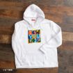 A white hoodie on a wooden floor features a colorful square graphic with bold, multicolored text reading “HOW YOU DOIN?” on the chest.