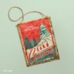National Lampoon’s Christmas Vacation hanging metal sign featuring the Griswold family walking toward a snow-covered tree, with a station wagon carrying a tree in the foreground.