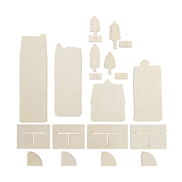 Unassembled wooden craft pieces for a small village, including building facades, trees, rectangular bases with slots, and quarter-circle corner supports.